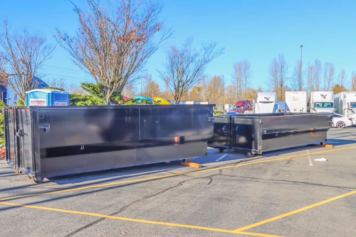 Professional dumpster rental service with roll-off container on residential driveway in Belleview